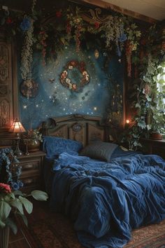 a bed with blue sheets and pillows in a room decorated with flowers on the wall