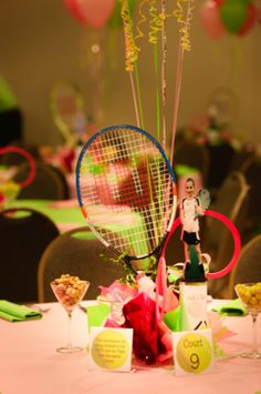 a tennis racket and some balloons on a table