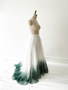 a dress on a mannequin with green and white ombreached skirt