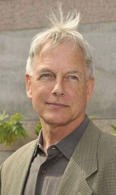 an older man with white hair wearing a suit