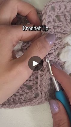 a woman is crocheting with her hands