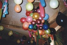 many balloons are hanging from the ceiling in this room