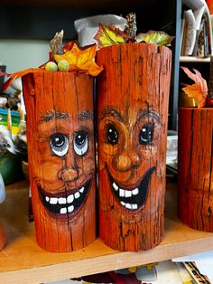 two wooden logs with faces painted on them