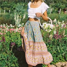 This stunning boho maxi skirt is perfect for the free-spirited fashionista. Its flowy design and colorful floral print make it a must-have for any bohemian wardrobe. Embrace your inner free spirit with this versatile and stylish skirt. Bohemian Floral Print Beach Bottoms, Bohemian Floral Beach Bottoms, Summer Floral Print Wide Leg Maxi Skirt, Bohemian Midi Skirt For Summer, Bohemian Relaxed Skirt, Flowy Boho Print Tiered Maxi Skirt, Hippie Floral Print Maxi Skirt For Vacation, Hippie Floral Print Maxi Skirt For The Beach, Summer Bohemian Relaxed Maxi Skirt