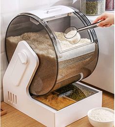 a person scooping grain from a machine into a bowl