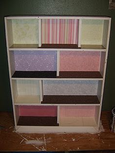 a book shelf filled with lots of different types of papers on top of each other