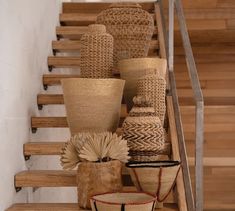 several vases are lined up on the stairs