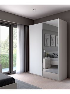 a bedroom with a large mirror on the wall next to a bed and sliding glass doors