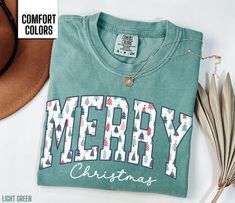 You will love this Merry Christmas shirt for women.  It says Merry in a beautiful Christmas tree font along with Christmas in a script font. This will be the perfect shirt for any woman to wear this holiday season.  Share your Christmas cheer with others this winter. Find our long sleeve tee and crewneck sweatshirts here: Short Sleeve Tee: https://etsy.me/4dGGUaR Long Sleeve Tee: https://etsy.me/3U0W2sW Crewneck Sweatshirt: https://etsy.me/4dxXqKl Comfort Colors T shirt Details: 100% ring-spun c Christmas Shirt For Women, Christmas Green T-shirt With Letter Print, Green Christmas T-shirt With Letter Print, Holiday Green T-shirt With Letter Print, Winter T Shirt, Homemade Shirts, Christmas Shirts For Women, Diy Shirts, Winter T Shirts