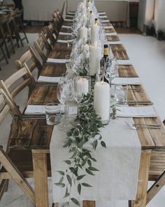 the table is set with candles and place settings for guests to sit down at it