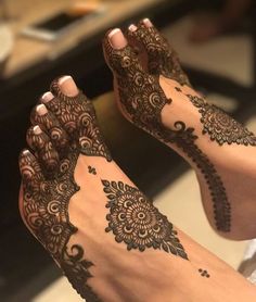 the feet are decorated with henna and flowers