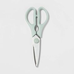 a pair of green scissors on a white background