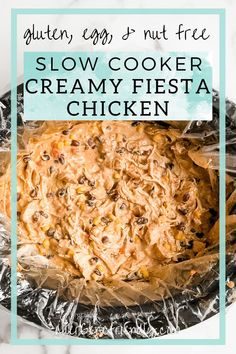 an image of slow cooker creamy fiesta chicken in foil on a white table with text overlay