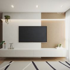 a flat screen tv mounted to the side of a white wall in a living room