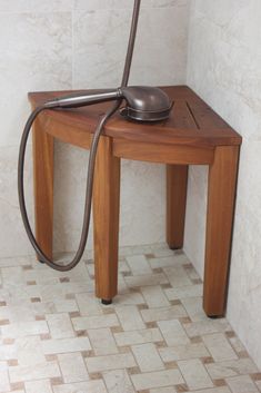 a table with a phone on it and a hose attached to the top of it