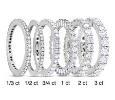 a set of five different sized wedding rings with white diamonds on each ring and the width is