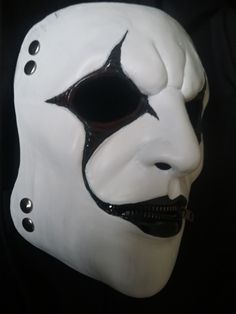 a white mask with black accents on it