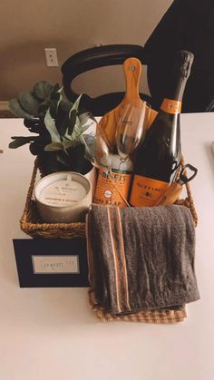 a basket filled with wine and other items