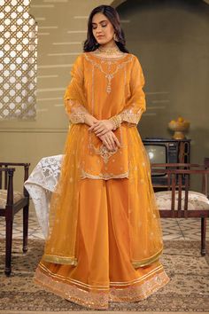 Mustard Orange Embroidered Pakistani Kameez Sharara Party Dress exemplifies exclusive cutwork, superior details on lustrous draperies for your approaching. Organza Churidar With Dabka In Traditional Drape, Semi-stitched Raw Silk Eid Dress, Eid Shantoon Lehenga With Traditional Drape, Festive Organza Salwar Kameez For Eid, Traditional Organza Dress For Festivals, Eid Sharara With Sheer Dupatta In Shantoon, Eid Embroidered Organza Sharara, Embroidered Organza Sharara For Eid, Eid Dresses With Resham Embroidery