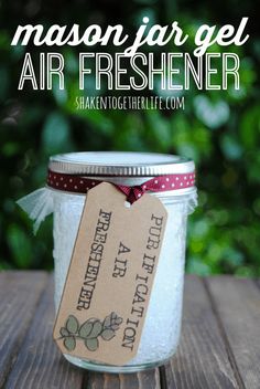 a mason jar filled with air freshener sitting on top of a wooden table