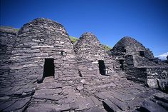 an old stone building with three windows on the top and one window in the middle