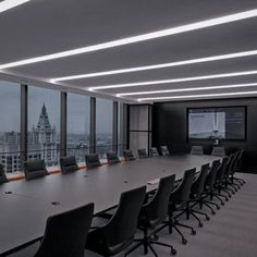 an empty conference room with large windows overlooking the city