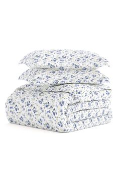 the blue and white floral print sheets are folded on top of each other