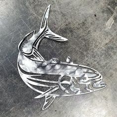 a metal fish is shown on the ground