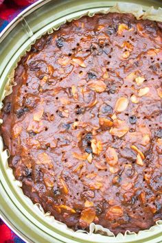 a baked dish in a pan on top of a red and blue table cloth,