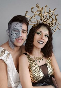 a man and woman with painted faces pose for a photo