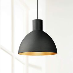 a black pendant light hanging from a ceiling in a room with white walls and windows