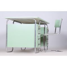 a mint green office desk with two chairs