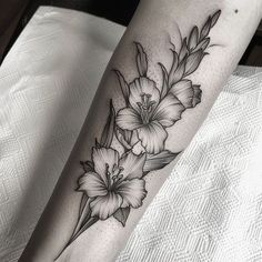 a black and white flower tattoo on the leg