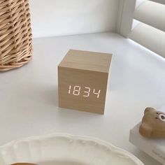 an alarm clock sitting on top of a white table