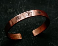 Dive into the captivating realm of personalized Sri Yantra Copper Bracelets, where ancient wisdom meets contemporary style! 🌟✨ Immerse yourself in the creative process as you Design Your Own Bracelet, sculpting a wearable masterpiece that reflects your unique energy and spirit. Our Adjustable Magnetic Copper Cuff is not just a piece of jewelry; it's a conduit for positive vibes, perfect for your yoga and healing journey. ️🌈 The meticulous craftsmanship of each bracelet encapsulates the profound symbolism of Sri Yantra, a sacred geometric pattern revered for its spiritual significance. 🌀✨ Customize your bracelet to be a true extension of your personality, a tangible representation of your inner self. 🌌💖 Copper, known for its healing properties, becomes a wearable talisman in our creati Symbolic Round Cuff Bracelet Gift, Adjustable Personalized Bracelets, Unique Adjustable Engraved Bangle, Adjustable Symbolic Cuff Bangle Bracelet, Adjustable Symbolic Cuff Bracelet As Gift, Unique Adjustable Round Cuff Bracelet, Adjustable Symbolic Bangle Bracelet, Symbolic Adjustable Jewelry For Meditation, Adjustable Symbolic Jewelry For Meditation