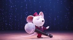 a cartoon mouse with a microphone on stage