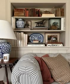 a living room filled with furniture and bookshelves covered in lots of different types of items