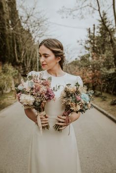 a woman in a white dress holding flowers