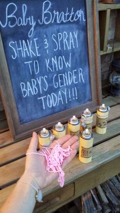 a chalkboard sign that says baby brother shake 3 spray to know baby's gender today