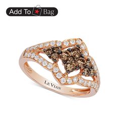 a brown and white diamond ring with the name levian written in gold on it