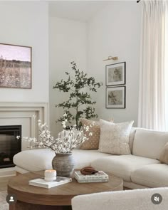 a living room filled with furniture and a fire place in front of a painting on the wall