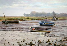 three boats are sitting in shallow water