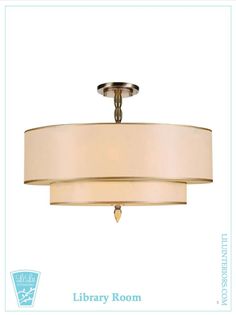 a light fixture with a beige shade on the bottom and white drum lights above it