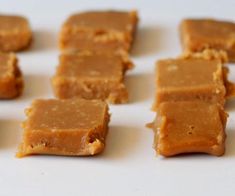 several pieces of peanut butter on a white surface