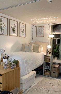 a bedroom with white walls and pictures on the wall