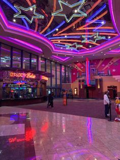 the inside of a shopping mall with colorful lights