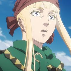 an anime character with long blonde hair wearing a green shirt and red bandanna on her head