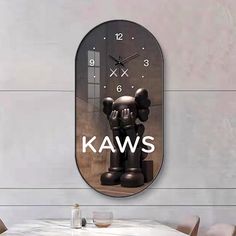 a wall clock with the words kaws on it and a cartoon character in front