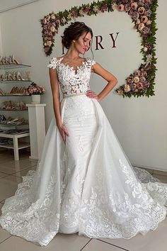 a woman in a white wedding dress posing for the camera