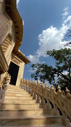 the stairs lead up to an ornate building